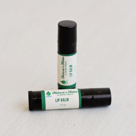Photo of two black plastic tube of lip balm