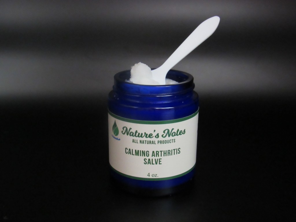 Cobalt blue 3 oz jar with white Calming Arthritis Salve with scooping spatula.