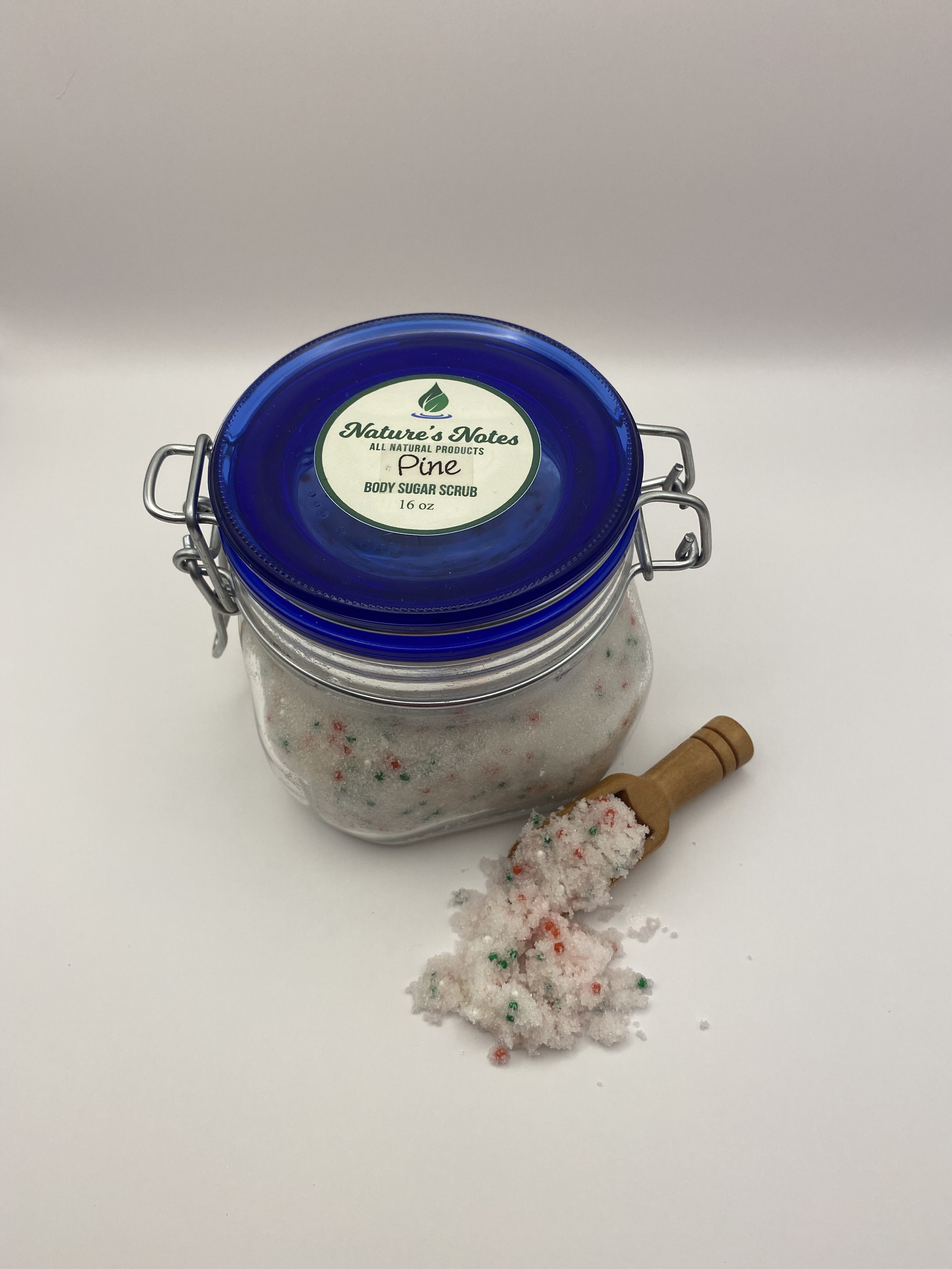 Cobalt blue and clear flip lid Pine Sugar Scrub with green and red colored beads for the holidays. Bamboo scoop included.